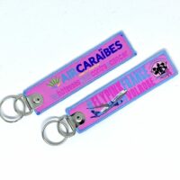 Porte clé "flamme" Air Caraïbes Vol Rose